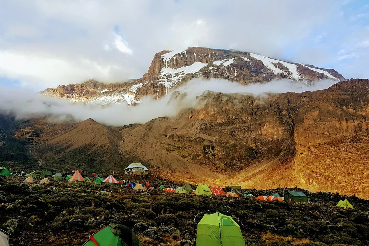 Tented camp below the rocky upper slopes of Mount Kilimanjaro